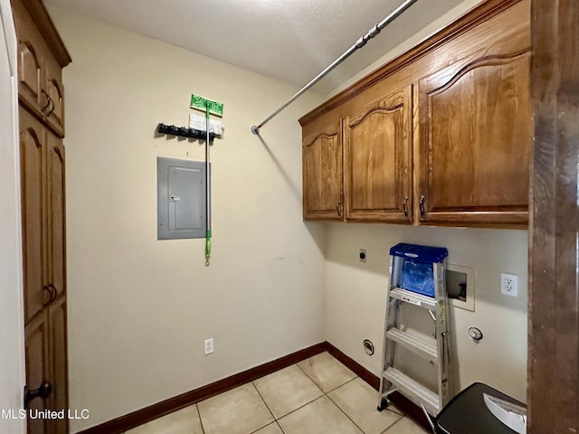 clothes washing area featuring light tile patterned flooring, washer hookup, electric panel, cabinet space, and electric dryer hookup