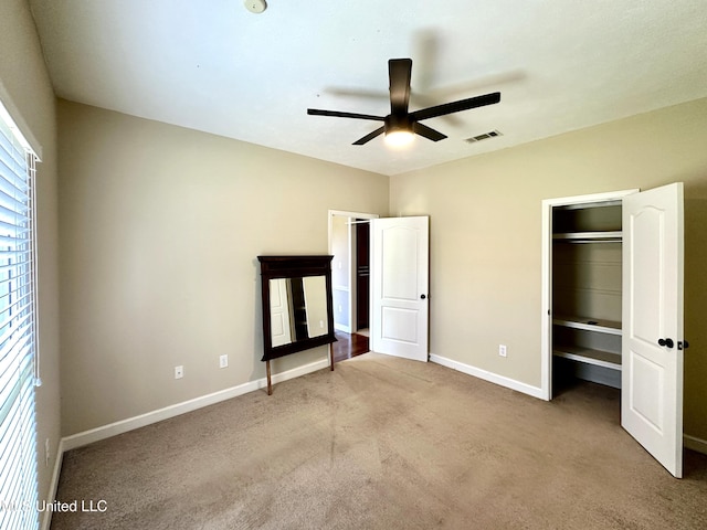 unfurnished bedroom with carpet, visible vents, baseboards, and a ceiling fan