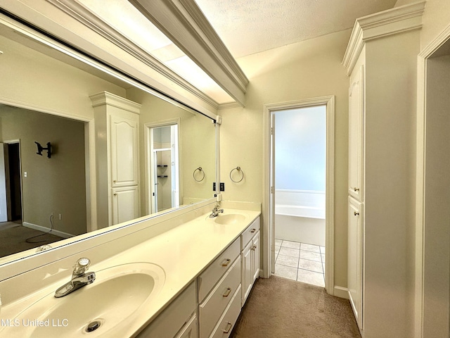 bathroom with a sink, double vanity, a garden tub, and tile patterned floors