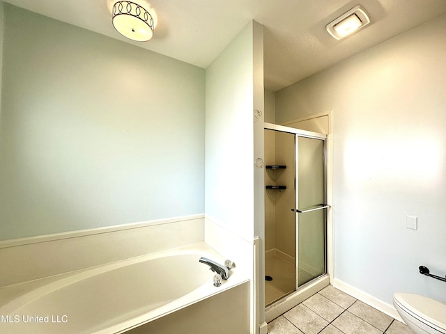 full bathroom featuring tile patterned floors, a bath, toilet, and a shower stall
