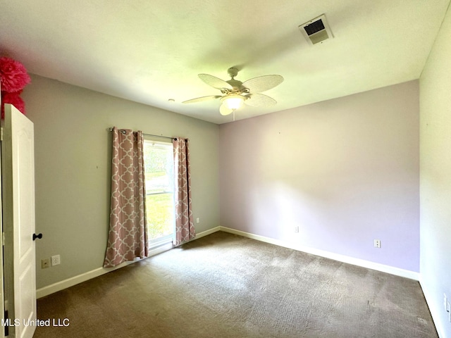 carpeted empty room with baseboards, ceiling fan, and visible vents