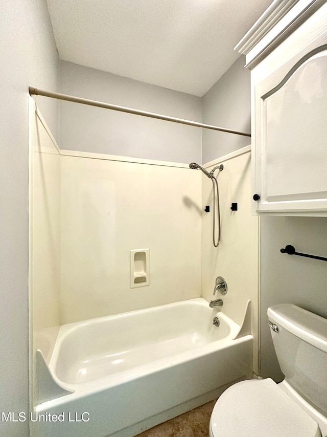bathroom with toilet, shower / tub combination, and a textured ceiling