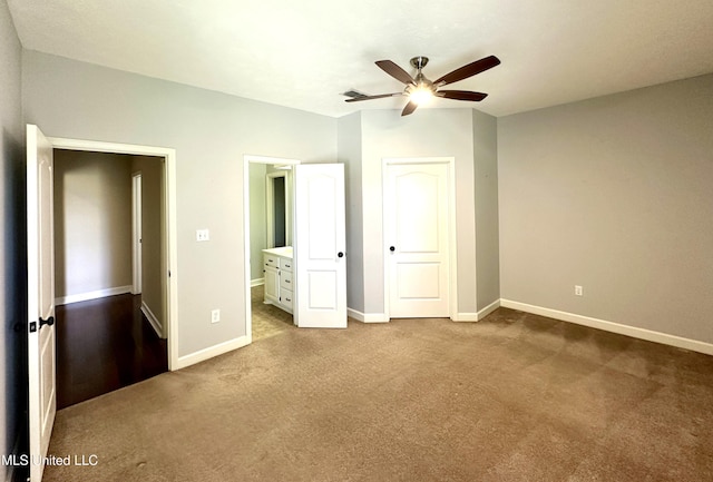 unfurnished bedroom with ensuite bathroom, carpet floors, and baseboards