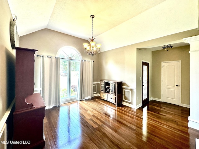 dining space featuring lofted ceiling, hardwood / wood-style floors, and a chandelier