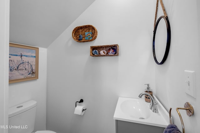 2207 Government St Unit 15, Ocean Springs, MS 39564 - half bath featuring vanity, toilet, and vaulted ceiling