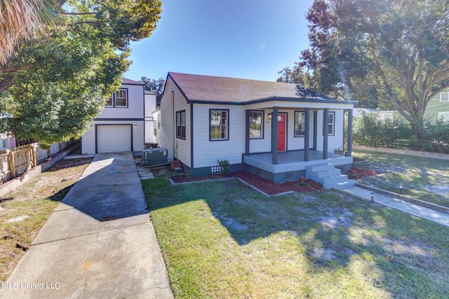 view of front of property with a front yard and a garage