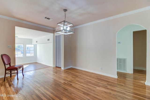 258 Porter Ave, Biloxi, MS 39530 - spare room with wood finished floors, arched walkways, an inviting chandelier, baseboards, and visible vents
