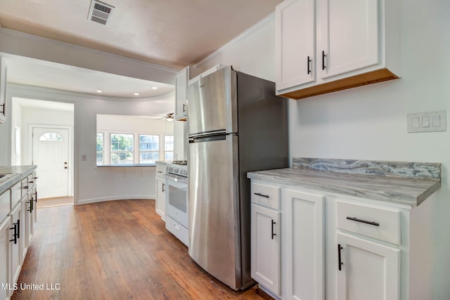 kitchen with stainless steel fridge, white cabinetry, light hardwood / wood-style flooring, crown molding, and white range