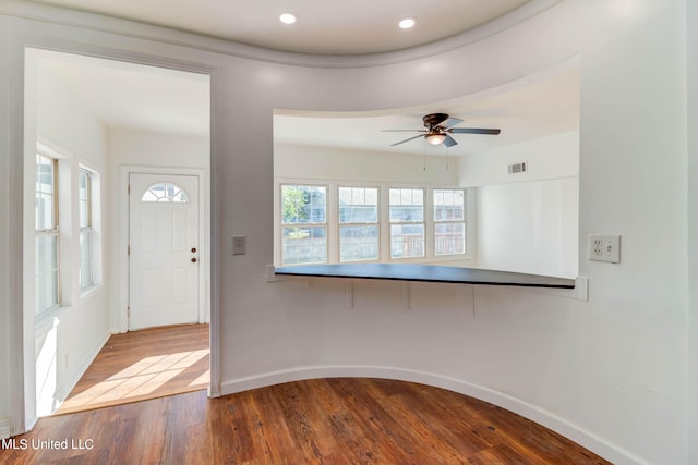 foyer entrance with ceiling fan and wood-type flooring