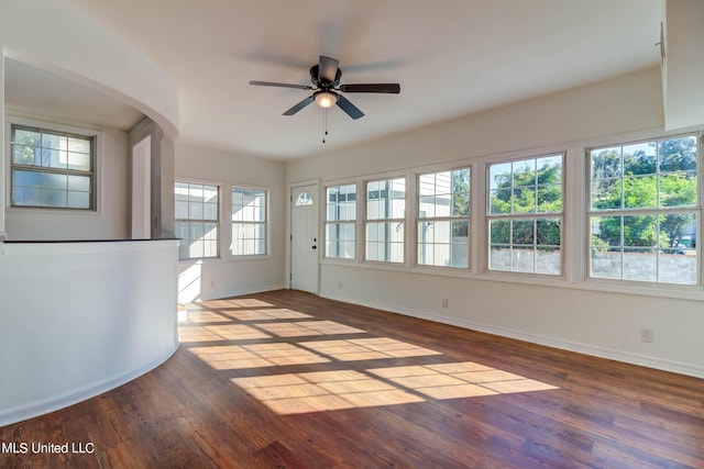 258 Porter Ave, Biloxi, MS 39530 - interior space with baseboards, a ceiling fan, wood finished floors, and arched walkways