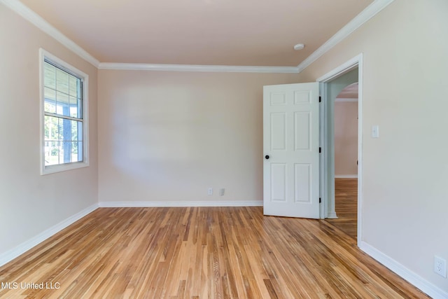 258 Porter Ave, Biloxi, MS 39530 - unfurnished room with arched walkways, crown molding, light wood finished floors, and baseboards