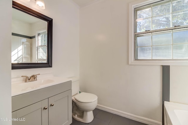 bathroom with vanity, toilet, a healthy amount of sunlight, and tile patterned floors