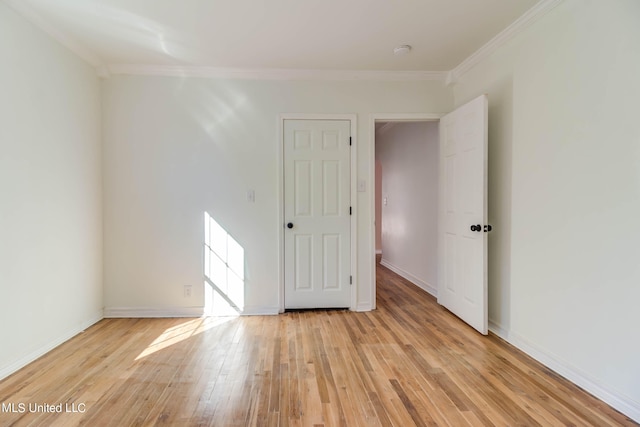 spare room featuring light hardwood / wood-style floors and ornamental molding