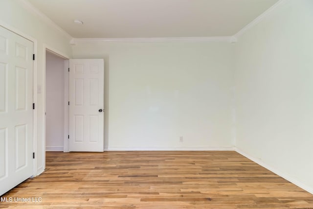 unfurnished room featuring ornamental molding and light hardwood / wood-style flooring