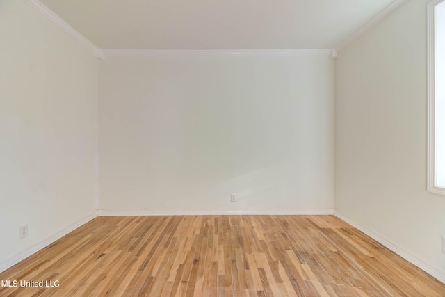 empty room featuring light hardwood / wood-style floors and ornamental molding