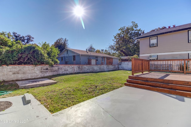 view of yard featuring a patio area and a deck