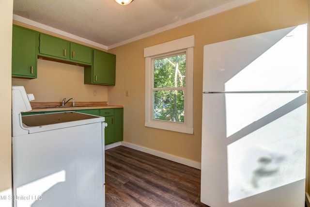 kitchen with white appliances, green cabinetry, a textured ceiling, ornamental molding, and dark hardwood / wood-style floors