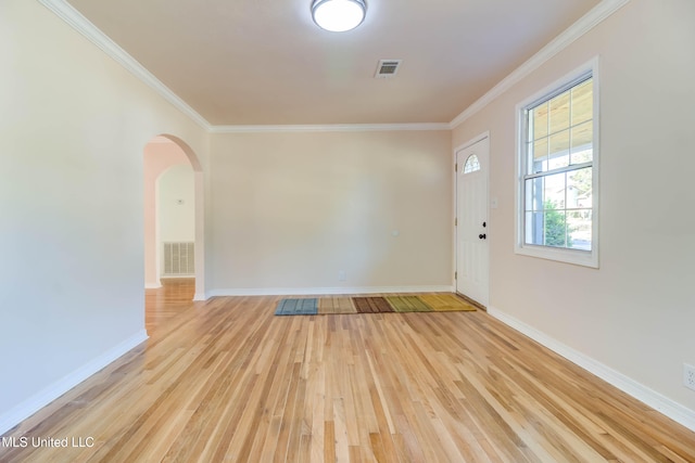 foyer entrance featuring ornamental molding and light hardwood / wood-style floors