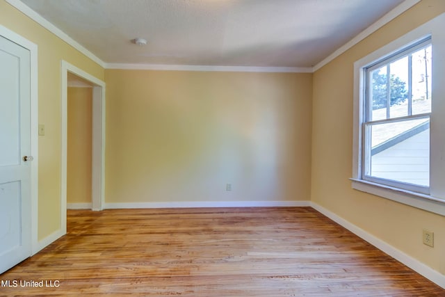 258 Porter Ave, Biloxi, MS 39530 - empty room with crown molding, light wood-type flooring, and plenty of natural light