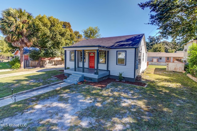 bungalow-style home with a front lawn