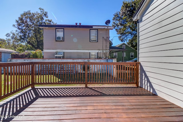 wooden terrace featuring a yard and cooling unit