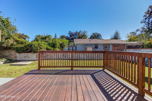 wooden deck featuring a yard