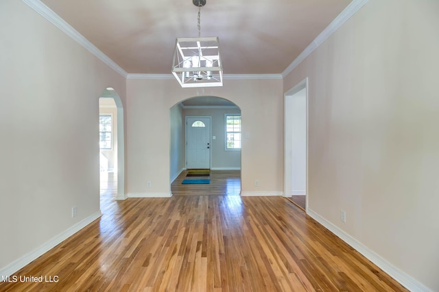 258 Porter Ave, Biloxi, MS 39530 - entrance foyer featuring baseboards, arched walkways, light wood-style floors, and crown molding