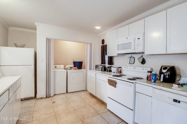 kitchen featuring white cabinets, light tile patterned floors, independent washer and dryer, crown molding, and white appliances