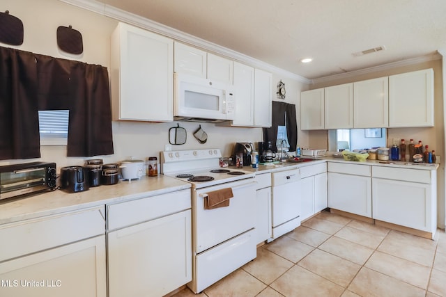 kitchen featuring sink, white appliances, crown molding, light tile patterned floors, and white cabinetry