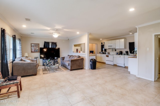 living room with ceiling fan and ornamental molding