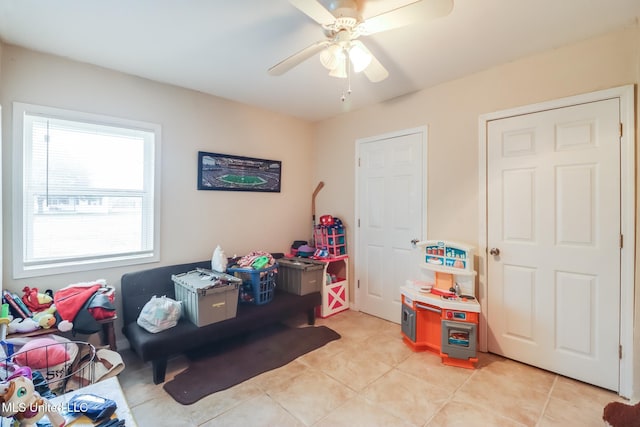 recreation room featuring ceiling fan and light tile patterned floors