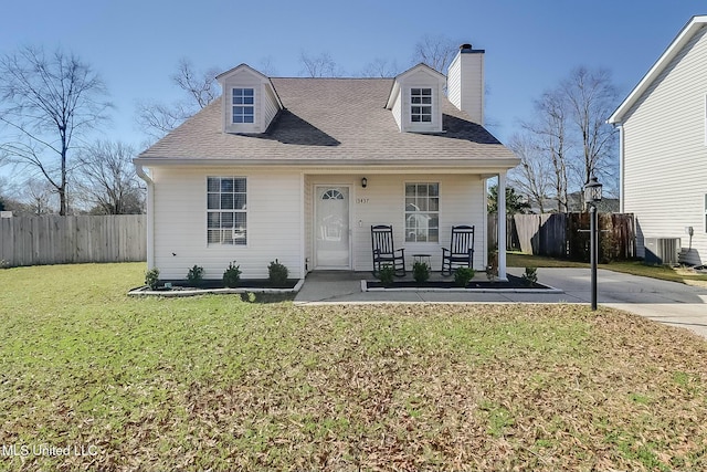 view of front of property with a porch, fence, roof with shingles, a front lawn, and a chimney