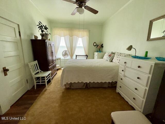 bedroom with ceiling fan and dark hardwood / wood-style floors