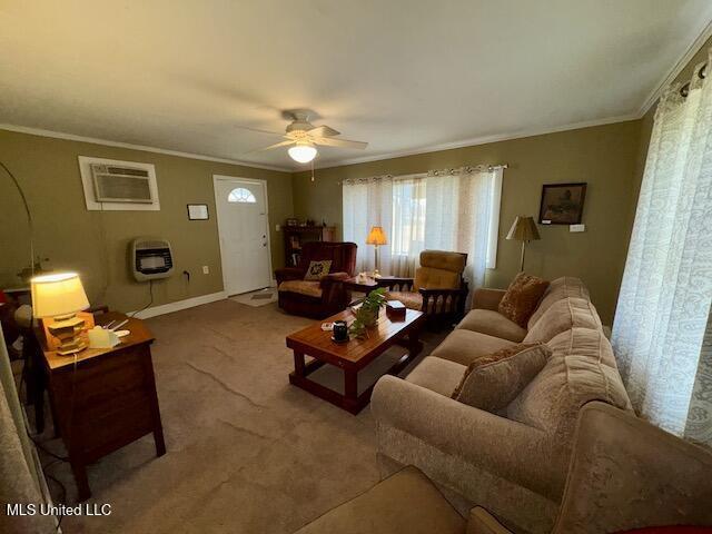 living room featuring crown molding, carpet, heating unit, and an AC wall unit