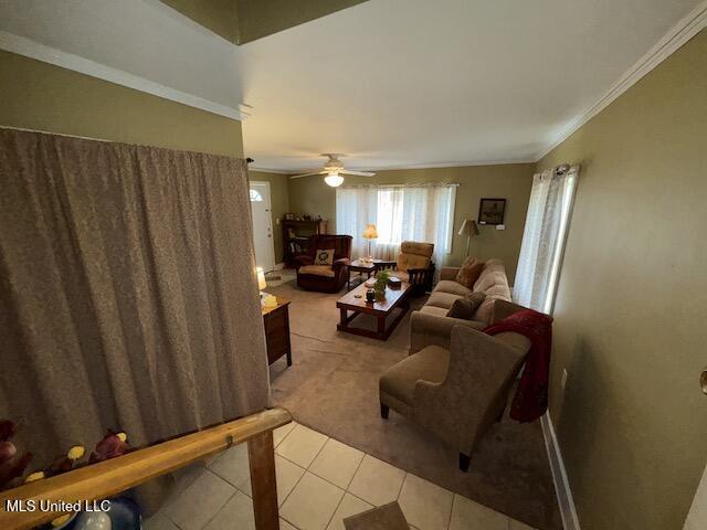 living room featuring light tile patterned floors and ornamental molding