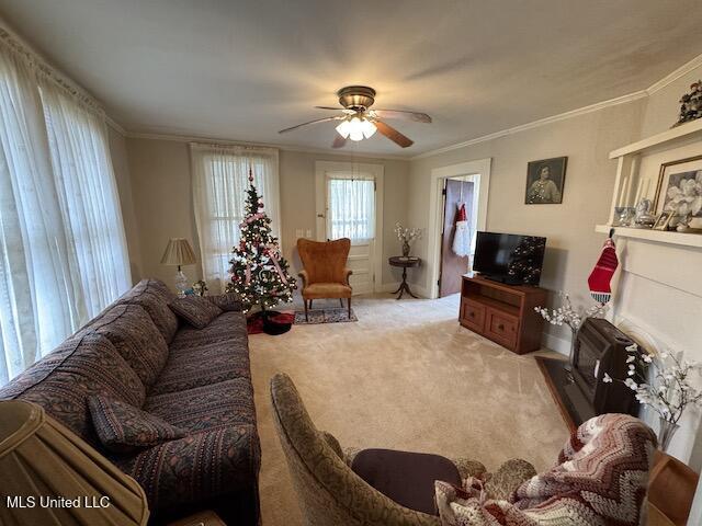 living room featuring light carpet, ceiling fan, and ornamental molding