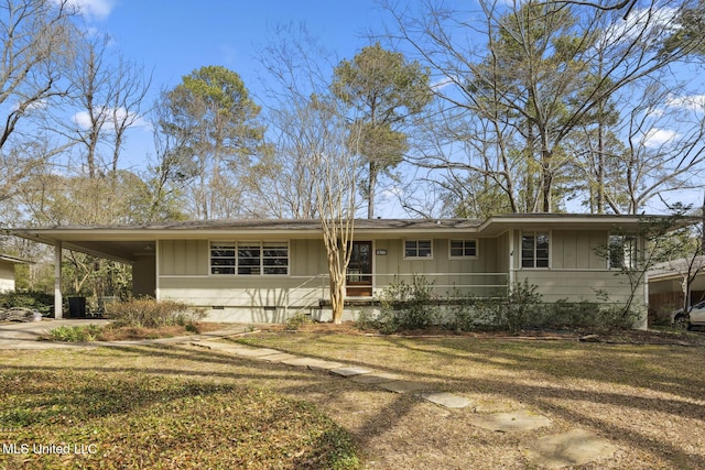 ranch-style home featuring a carport, crawl space, concrete driveway, and board and batten siding