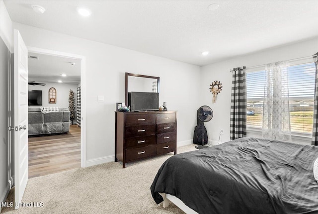 bedroom featuring recessed lighting, baseboards, and light carpet