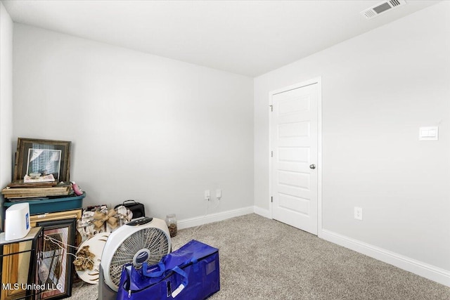 miscellaneous room with carpet, visible vents, and baseboards