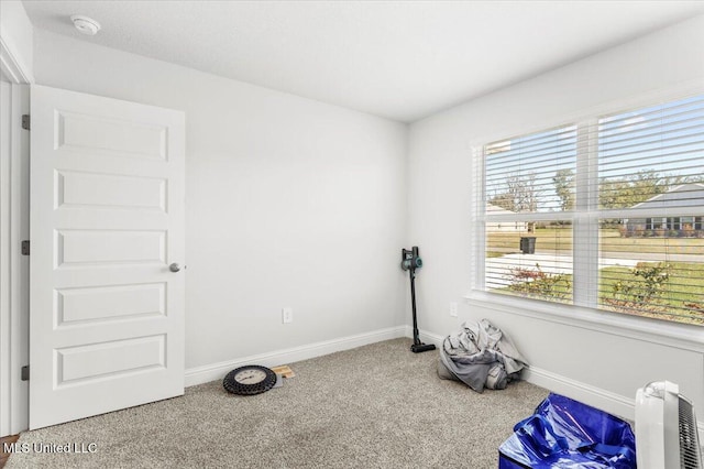 empty room with baseboards and carpet floors