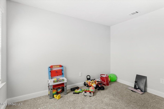 rec room featuring visible vents, baseboards, and carpet floors