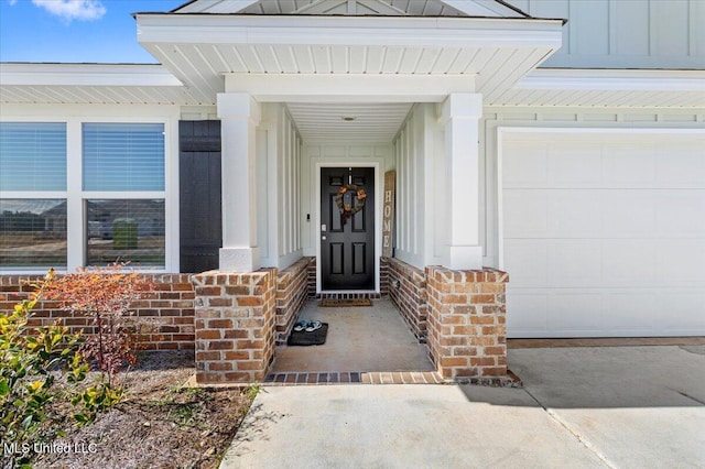 entrance to property featuring a garage and board and batten siding