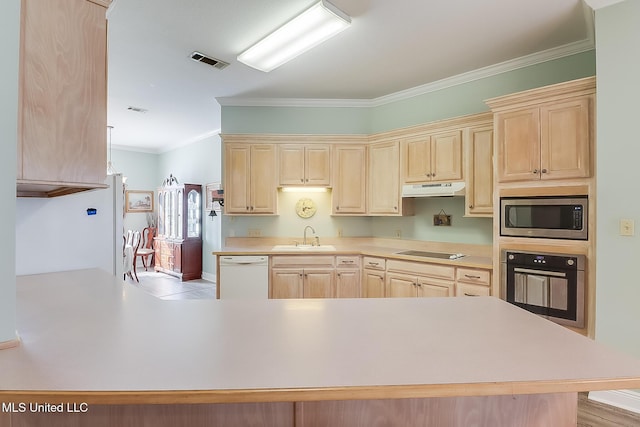 kitchen with light countertops, stainless steel microwave, wall oven, white dishwasher, and a peninsula