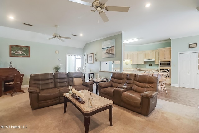 living room with baseboards, visible vents, crown molding, and recessed lighting