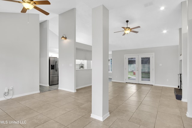 unfurnished living room featuring light tile patterned floors, visible vents, high vaulted ceiling, and ceiling fan