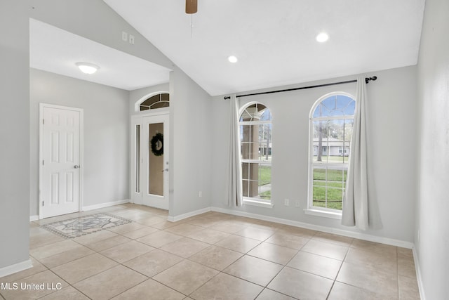 empty room with baseboards, vaulted ceiling, light tile patterned floors, recessed lighting, and a ceiling fan