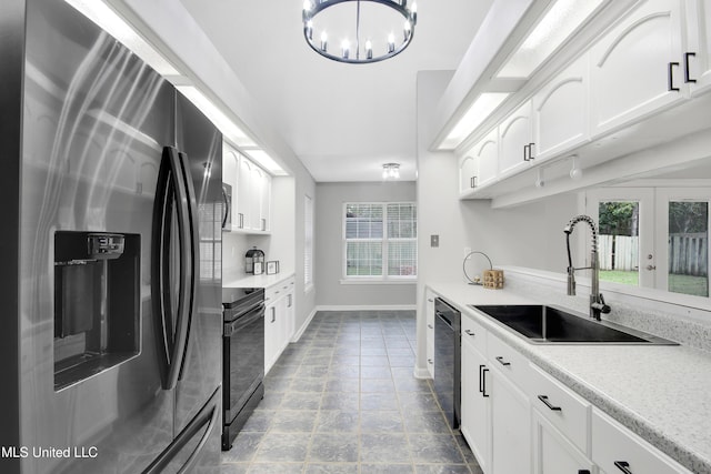 kitchen featuring electric range, a sink, white cabinets, dishwasher, and stainless steel fridge