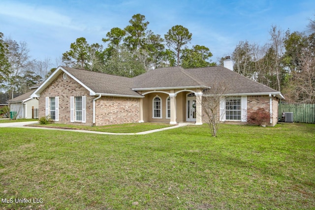 ranch-style house with a front lawn, brick siding, and a chimney