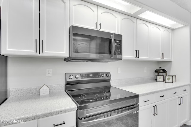 kitchen featuring appliances with stainless steel finishes and white cabinetry