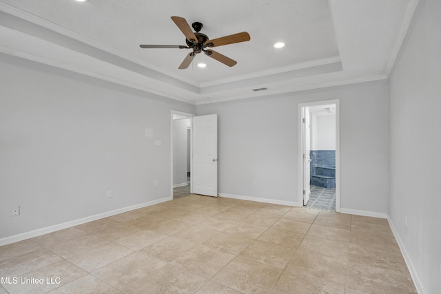 empty room featuring visible vents, baseboards, crown molding, a raised ceiling, and ceiling fan